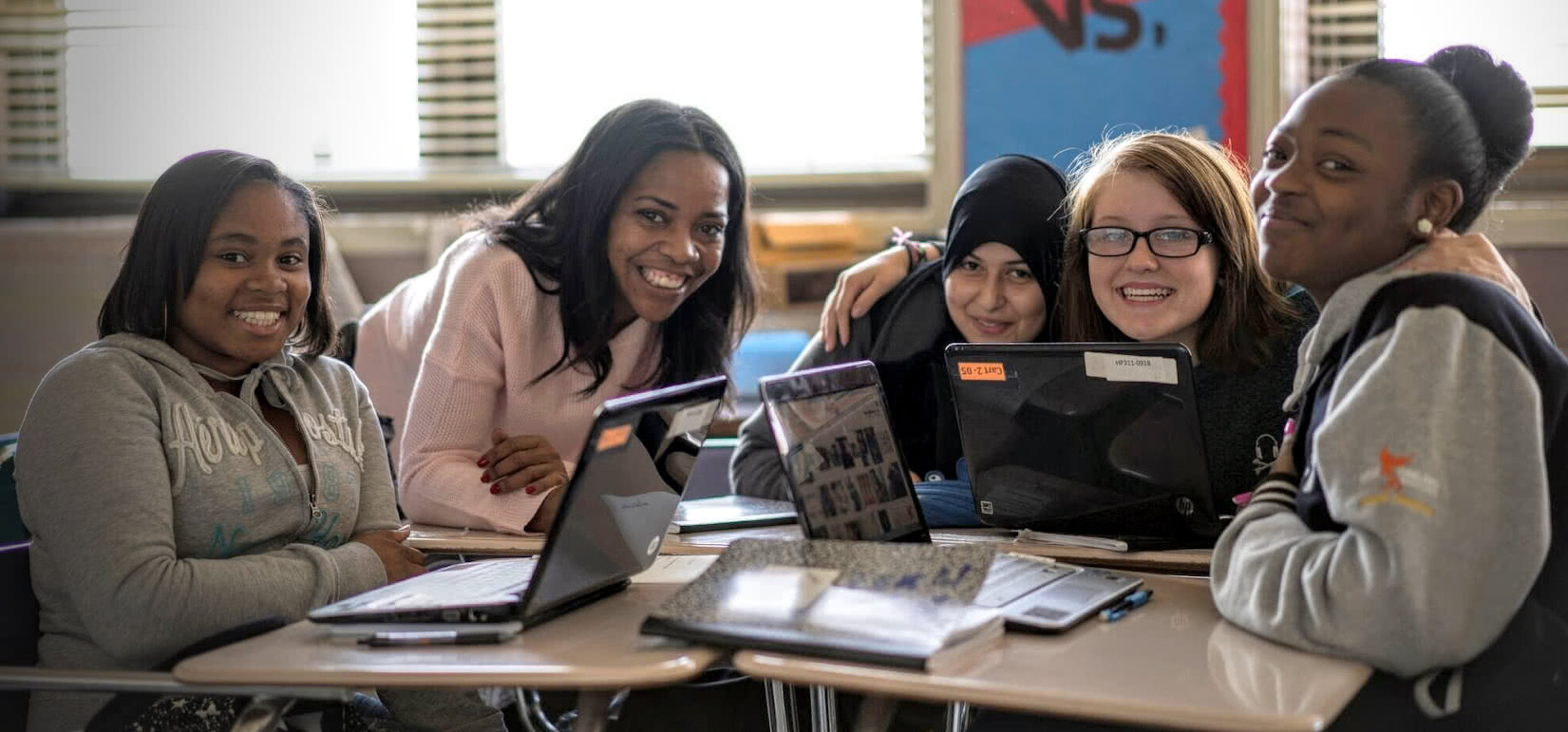 Teacher with diverse female students